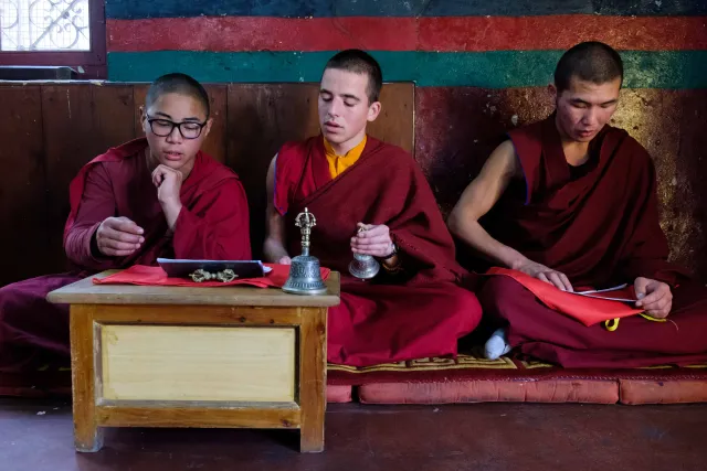 Three young student monks reciting memorized philosophical verses