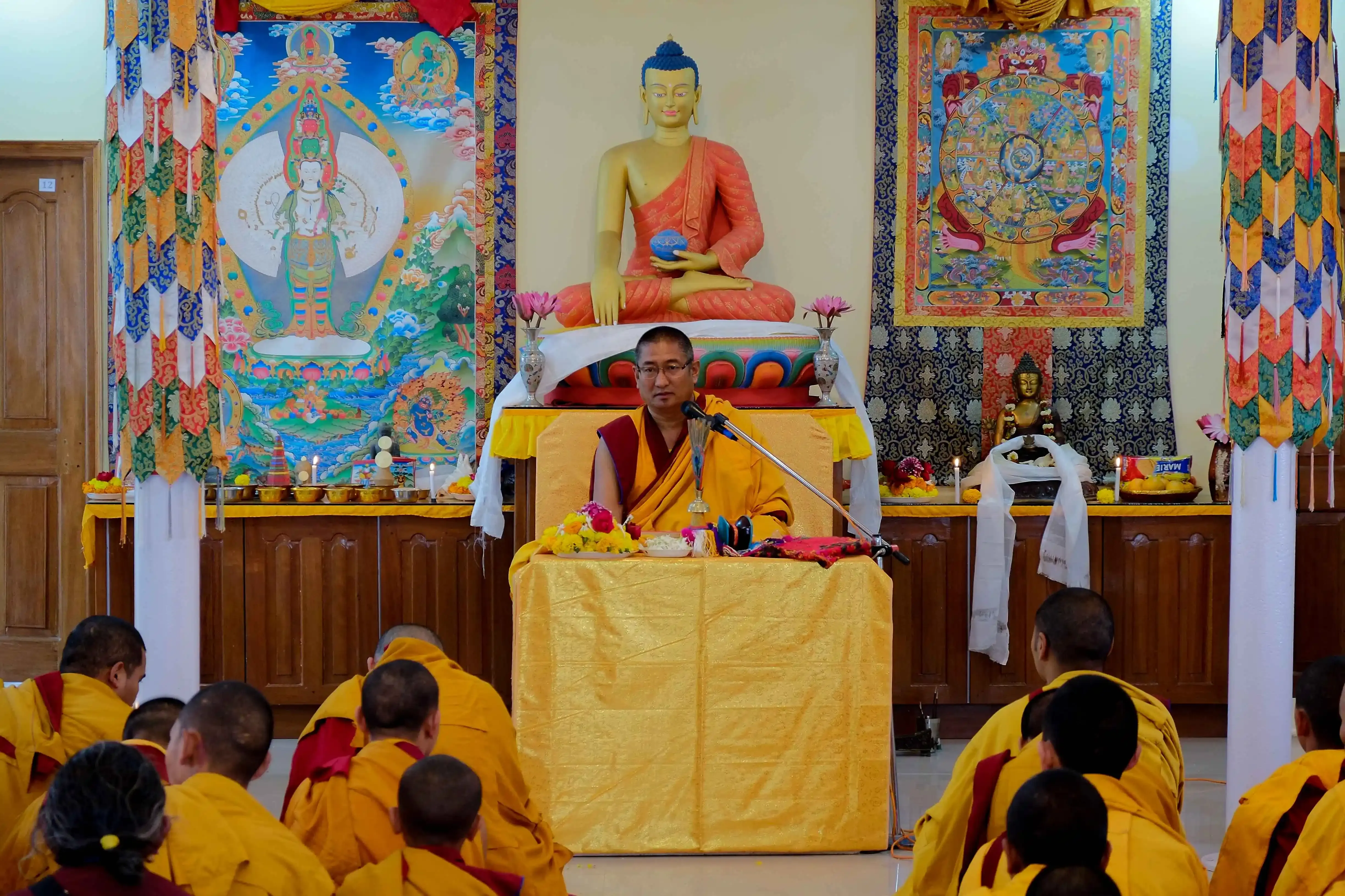 Monastic instructor conducting a lecture on Buddhist epistemology