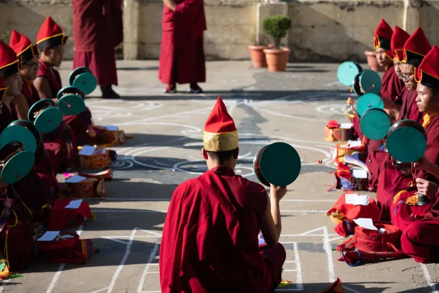 Sangha gathered in the monastery courtyard for traditional observances